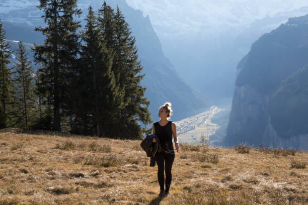 istock Young woman walks in mountain meadow 957155248