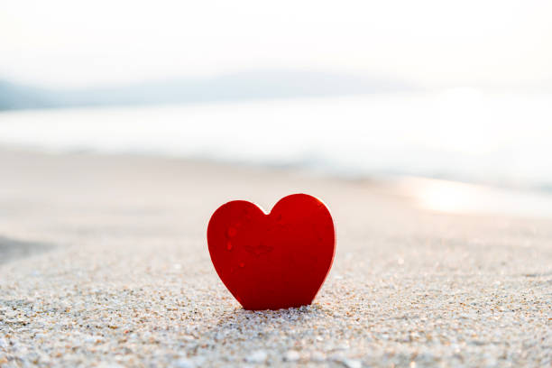 istock Red heart shape on the beach 957155728