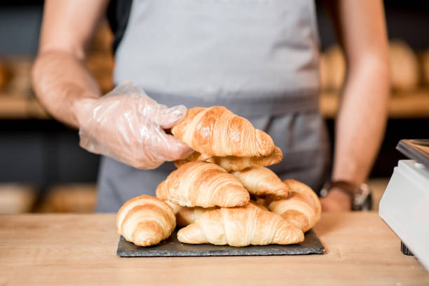 istock Serving croissants on the plate at the bakery 957156294