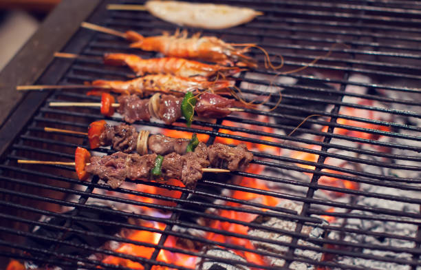 istock meat and srimps on grill fire Cooking BBQ seafood 957159370