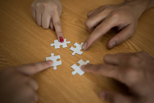 istock Man hands connecting couple puzzle piece in office. Business solutions, target, successful, goals and strategy concepts 957162234