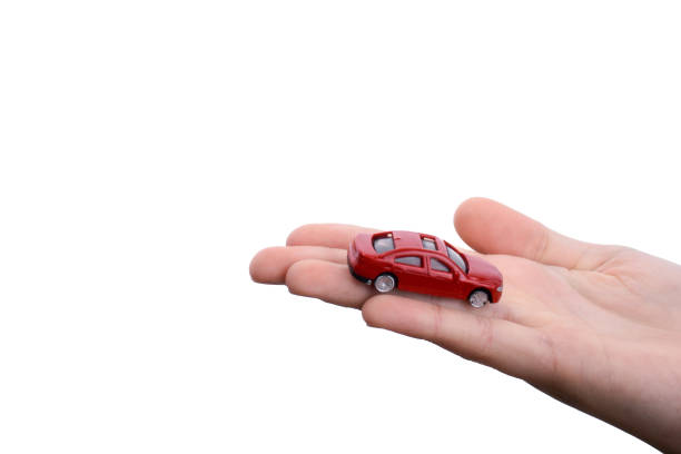 istock Child hand holding a red car 957163522