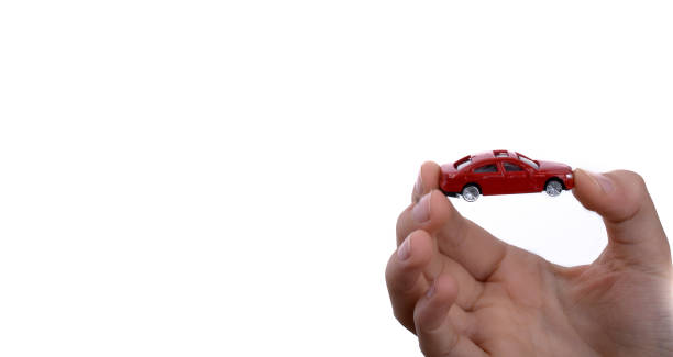 istock Child hand holding a red car 957163528