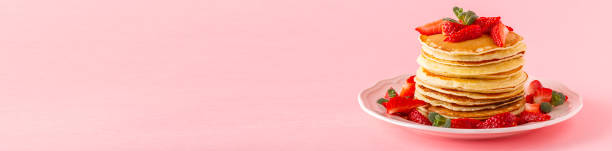 istock Pancakes with berries on a bright pastel background 957164852