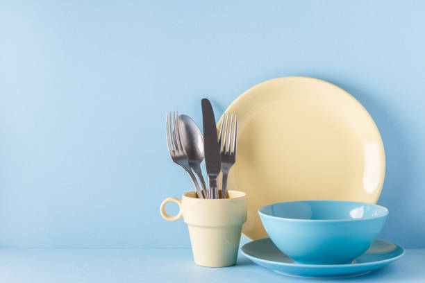istock Crockery and cutlery on a blue pastel background 957164978