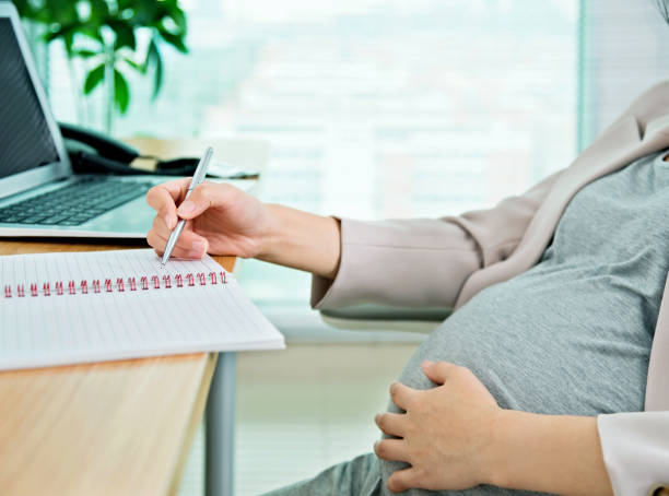 istock Pregnant woman writing in the office 957167480