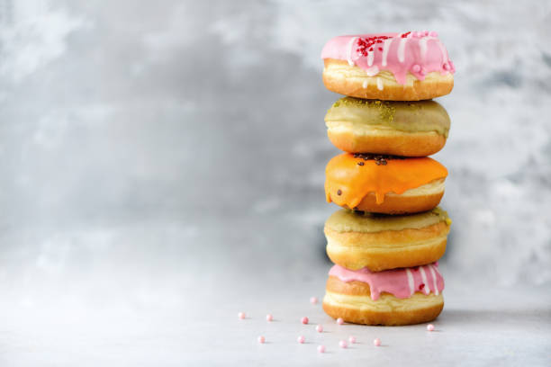 istock Sweet and colourful doughnuts on grey background. Fresh baked donuts. Copy space 957167546