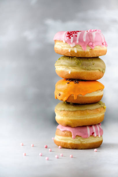 istock Sweet and colourful doughnuts on grey background. Fresh baked donuts. Copy space 957167586