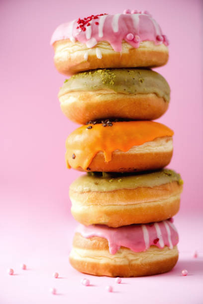 istock Sweet and colourful doughnuts on pink background. Fresh baked donuts. Copy space 957167668