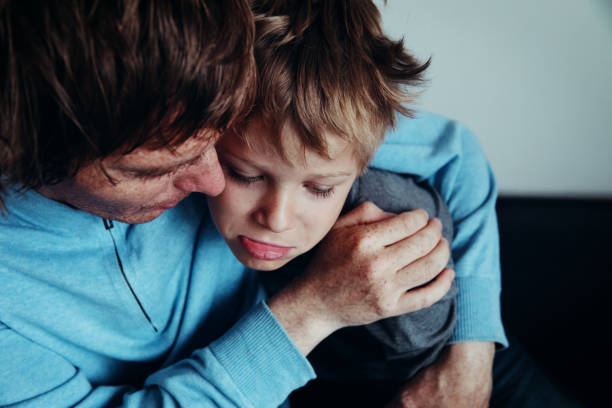 istock father comforting stressed sad son 957168244