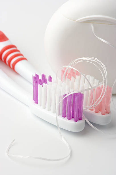 Two toothbrushes and dental floss stock photo