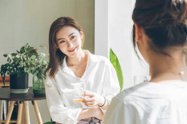 istock female friends sharing weekend time at home/cafe 957172976