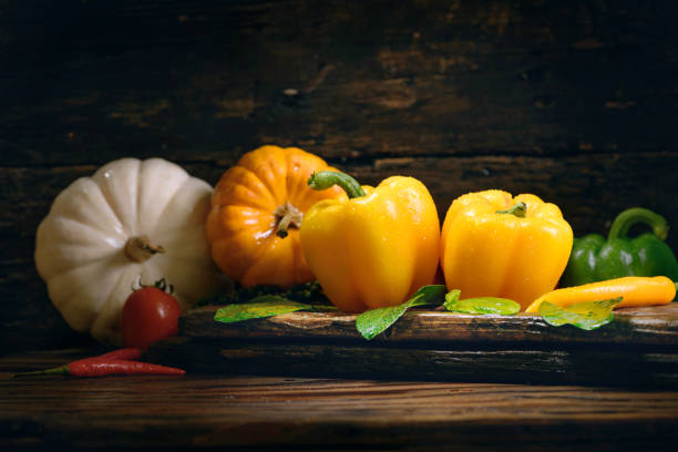 Bell pepper with vegetables on the old wooden floor.