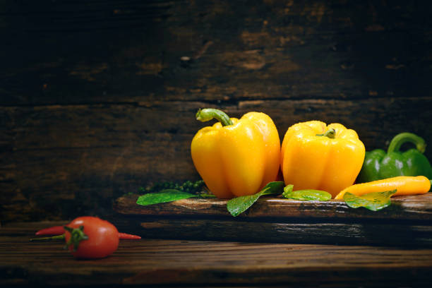 Bell pepper with vegetables on the old wooden floor.