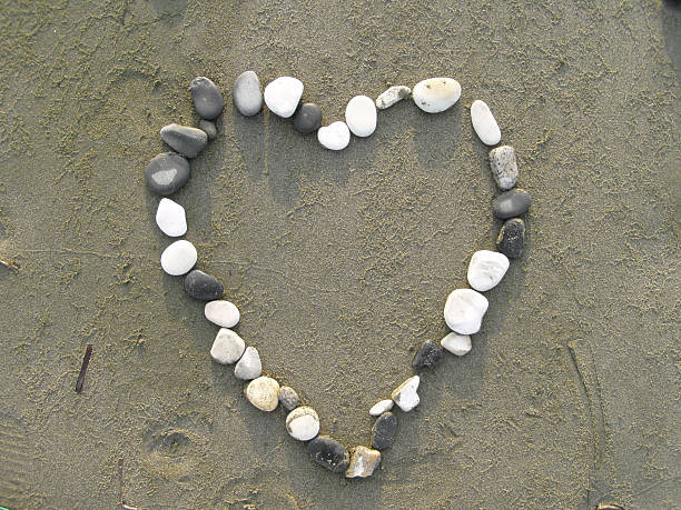 istock Heart made of pebbles on the sand. 95718060