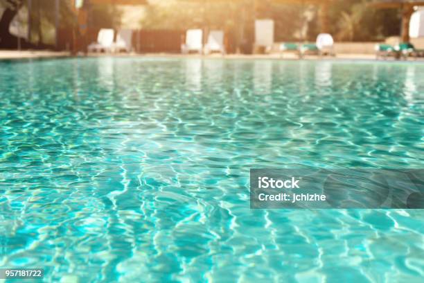 Summer Travel Vacation And Holiday Concept Lounge Chairs Near Swimming Pool Against Judean Desert Turquoise Pool With Clean Water Sun Beds Greens Of Bamboo Palms In Tourist Resort Stock Photo - Download Image Now