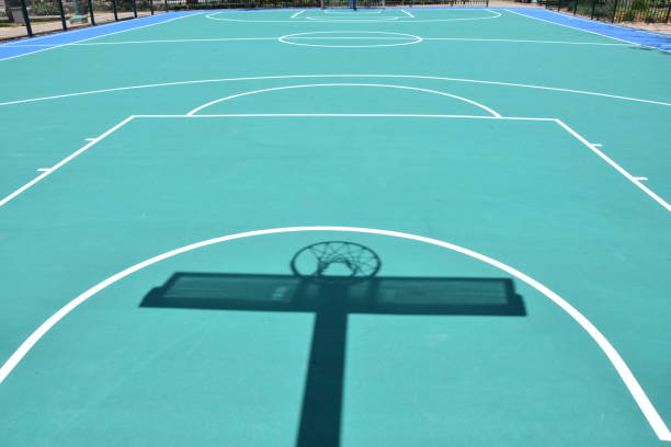 istock Shadow of basketball hoop 957182016