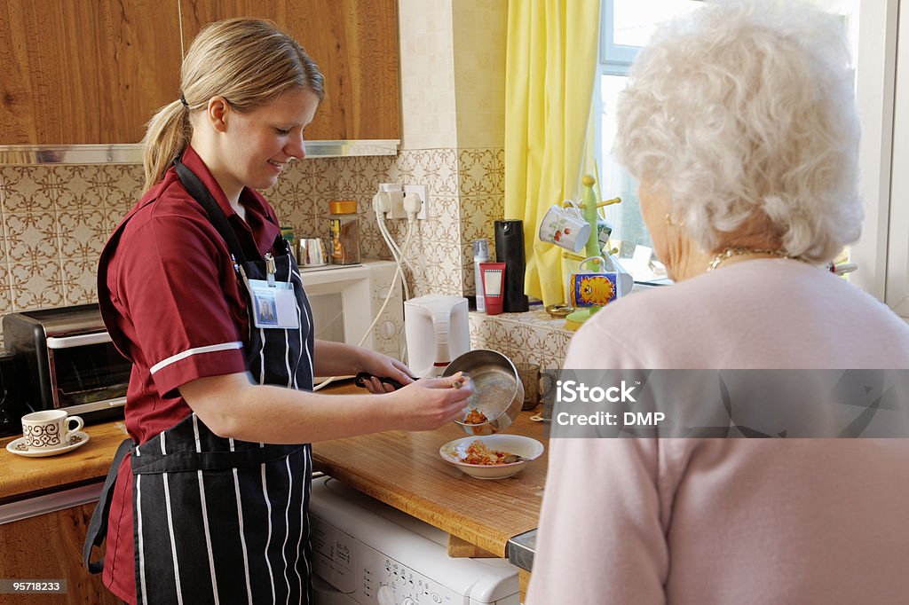 Junge Krankenschwester Küche für senior Frau in Ihrer Küche - Lizenzfrei Garkochen Stock-Foto