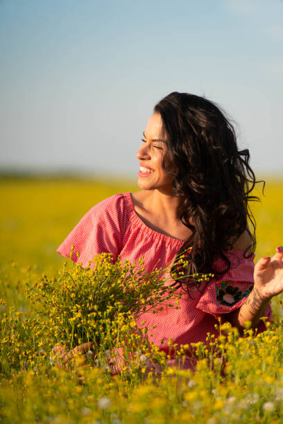 istock Smiling joyful woman in the meadow 957184788