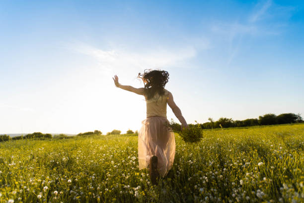 istock Running toward the sun in meadow 957187162