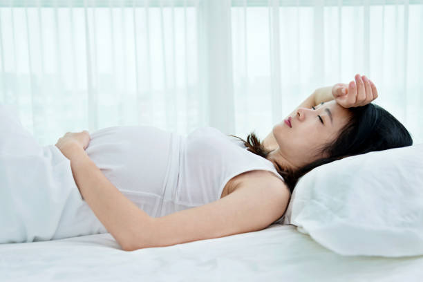 istock Pregnant woman sleeping in bed 957189744