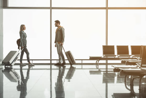 istock Positive lady going to glad male in terminal 957193406