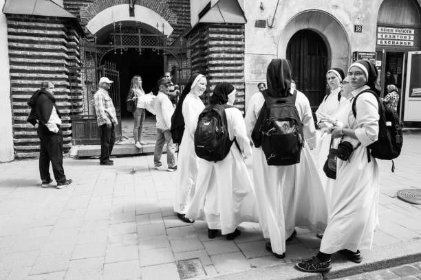 group of nuns near armenian virgin mary's dormition church in lviv - confessional nun catholic imagens e fotografias de stock