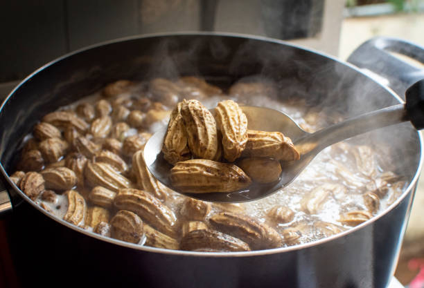 Peanuts boiled Boiled peanut,Peanuts boiled in ladle with boiling peanuts as a backdrop. boiled photos stock pictures, royalty-free photos & images