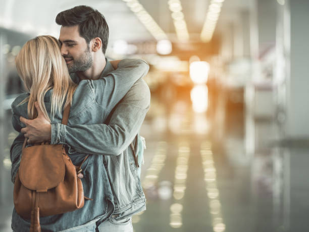 istock Glad male hugging female indoor 957194964