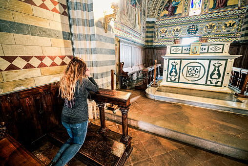 Girl pray kneeling in a church, religious subjects