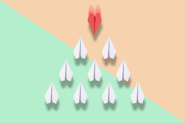 istock red paper plane leading white ones, leadership concept 957207294