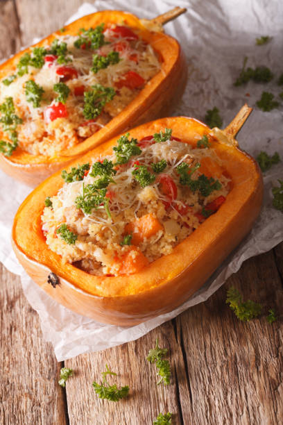istock Baked pumpkin stuffed with couscous, meat and cheese close-up. Vertical 957207484