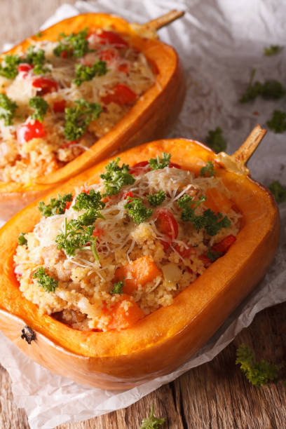 istock Baked pumpkin with couscous, meat, vegetables and cheese close-up. vertical 957208110