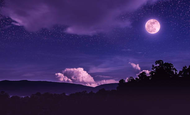 Landscape of night sky with many stars and beautiful full moon. stock photo