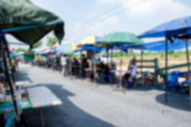 Abstract blurred people walking and shopping on street market daytime