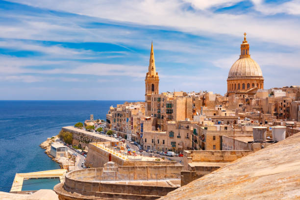 Domes and roofs of Valletta , Malta View from above of roofs and church of Our Lady of Mount Carmel and St. Paul's Anglican Pro-Cathedral, Valletta, Capital city of Malta valletta photos stock pictures, royalty-free photos & images