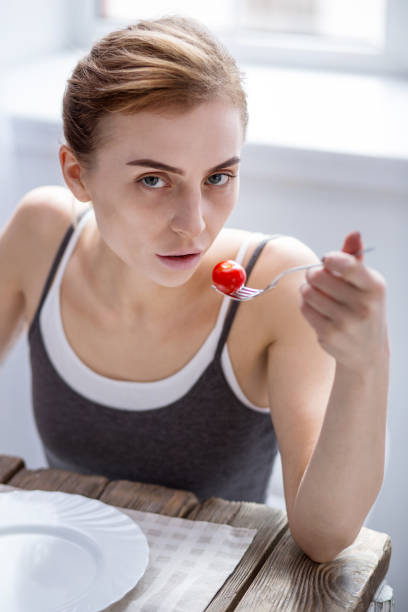istock Sad young woman watching her weight 957218702