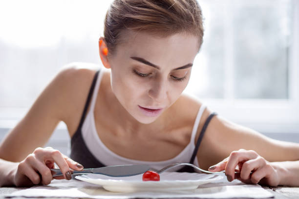 istock Sad young woman having meal 957218896