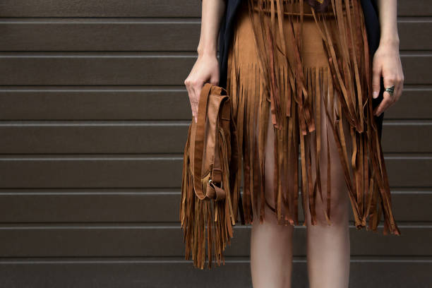 istock Brown fringe skirt and brown leather bag. 957219166