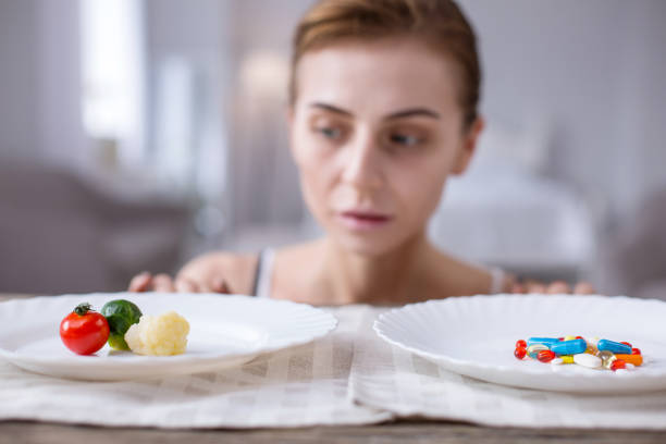 istock Sad young woman looking at the vegetables 957222528