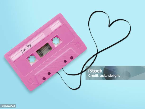 Pink Audio Cassette Tape With Label Tag Love Song Tangled Tape Ribbon Heart Shape Isolated On Blue Background Top View Stock Photo - Download Image Now