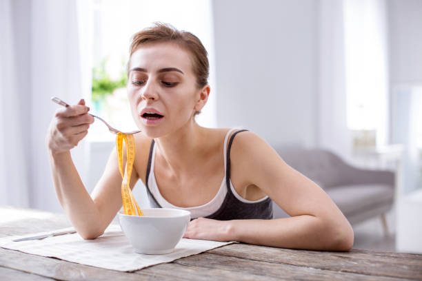 istock Pleasant young woman suffering from anorexia 957223162