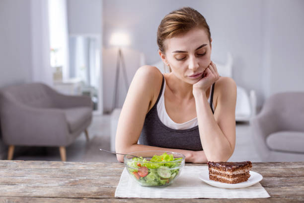 istock Thoughtful young woman looking at the cake 957224106