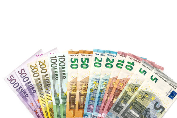 istock Euro banknotes isolated on white background, top view 957228340