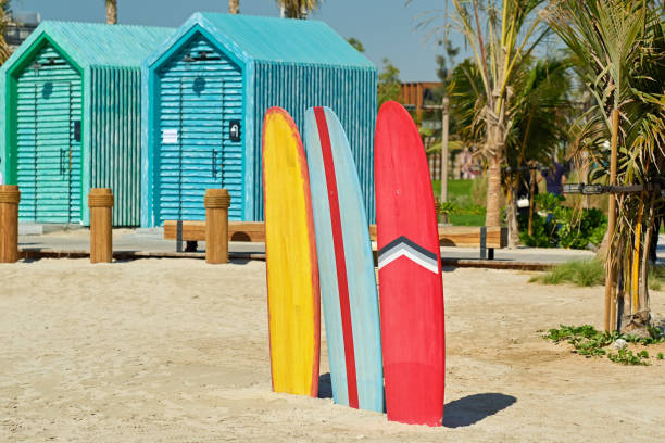 Surfboards and bathing cabins in Dubai Colored surfboards and beach bathing cabins in Dubai, United Arab Emirates hut photos stock pictures, royalty-free photos & images