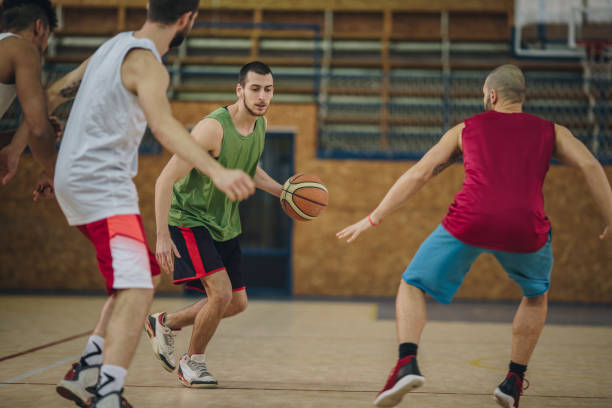 istock Determined basketball player in action during a match on a court. 957229078