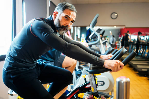 istock Mature man exercising at gym 957229338