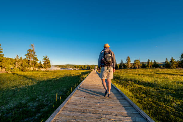 istock Tourists with backpack hiking in Yellowstone 957234310