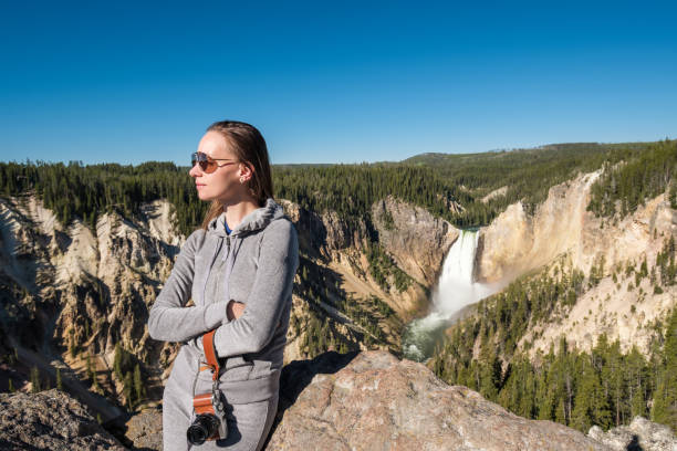istock Tourist overlooking waterfall in Yellowstone 957234418