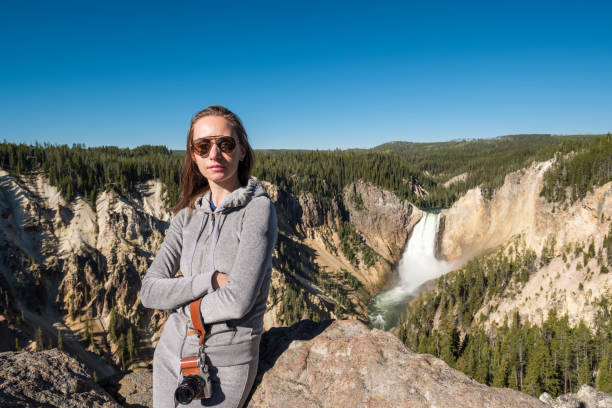 istock Tourist overlooking waterfall in Yellowstone 957234424